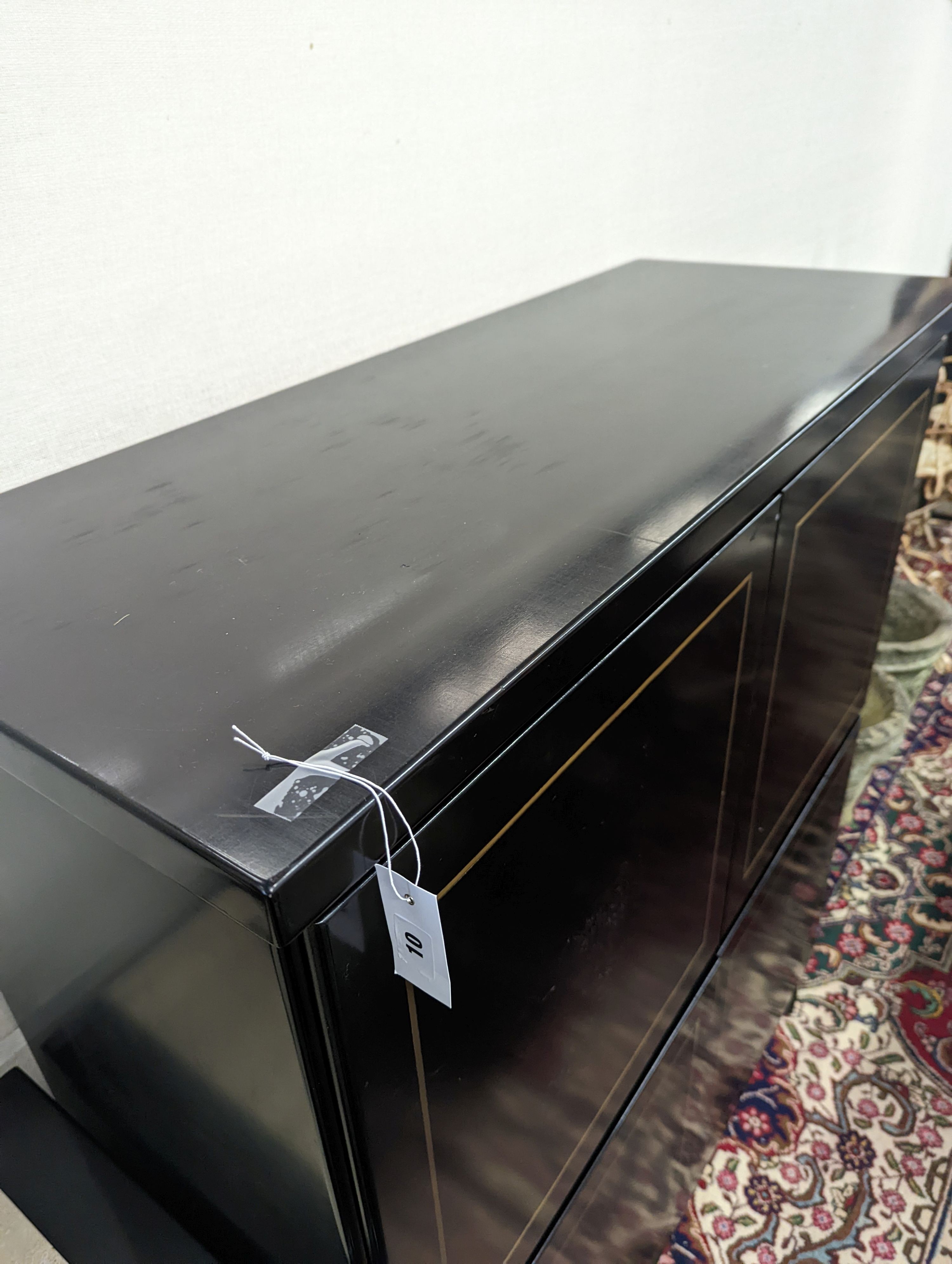 A 20th century black lacquer four door side cabinet, width 115cm, depth 45cm, height 135cm